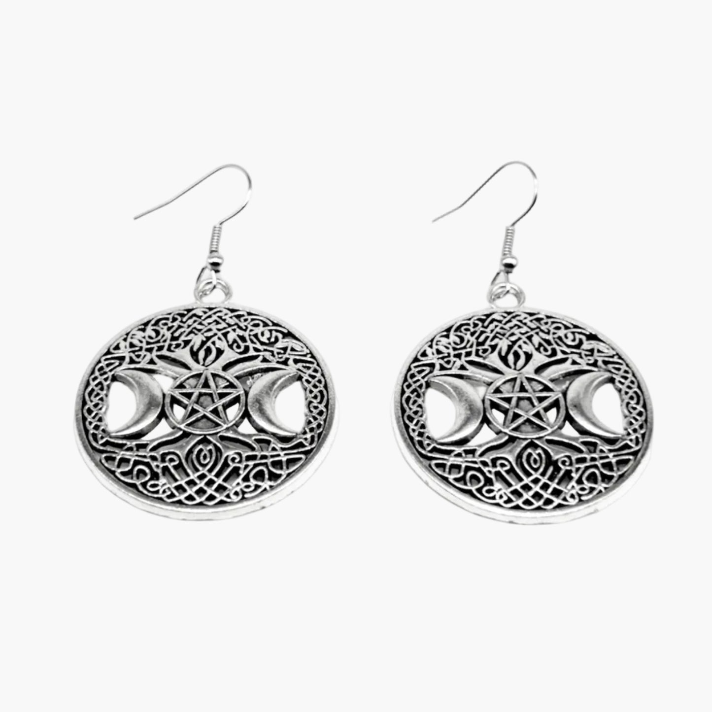 Close-up of silver pentagram earrings showing crescent moon etchings and sculpted design