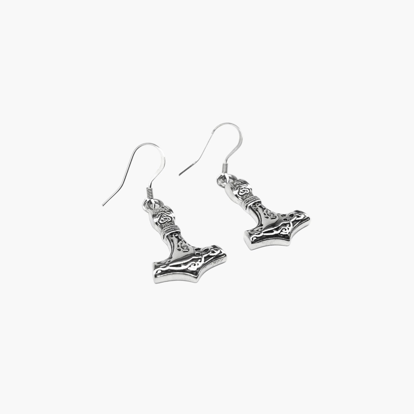 Close-up of Valkyrie Hammer earrings highlighting precise engraving and minimalist silver finish.