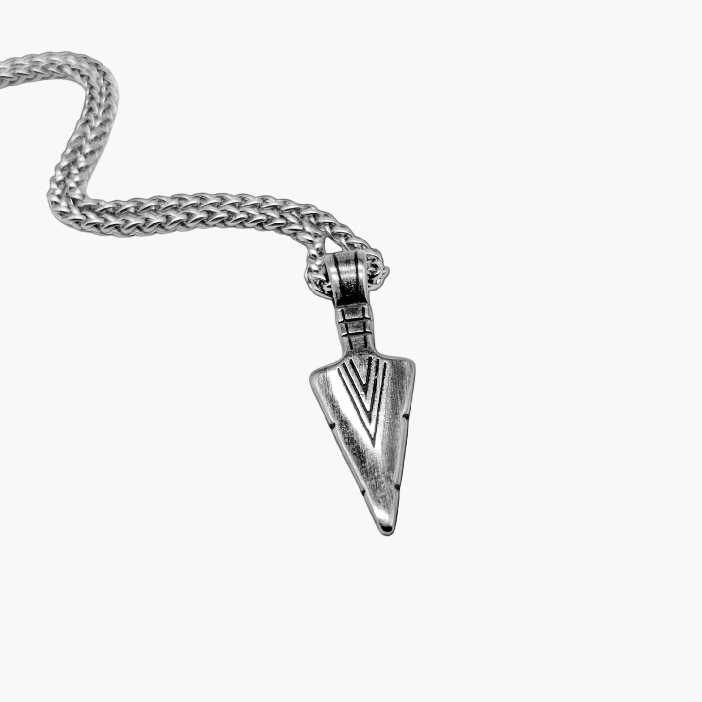 polished arrowhead detail on stainless steel pendant