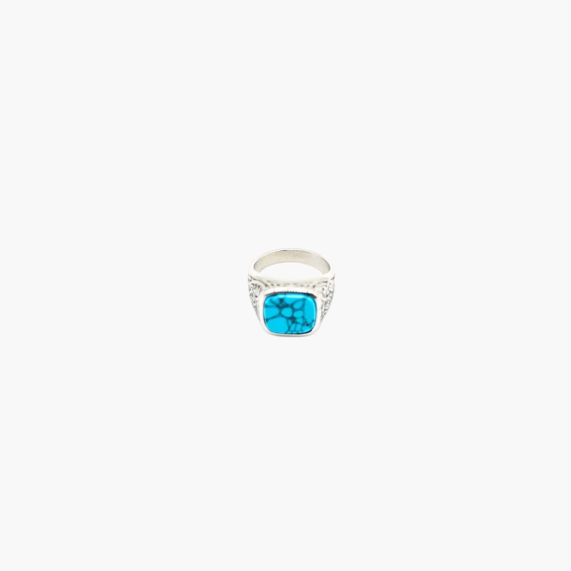 Top down view of men’s turquoise ring showing polished finish and bold minimalist design