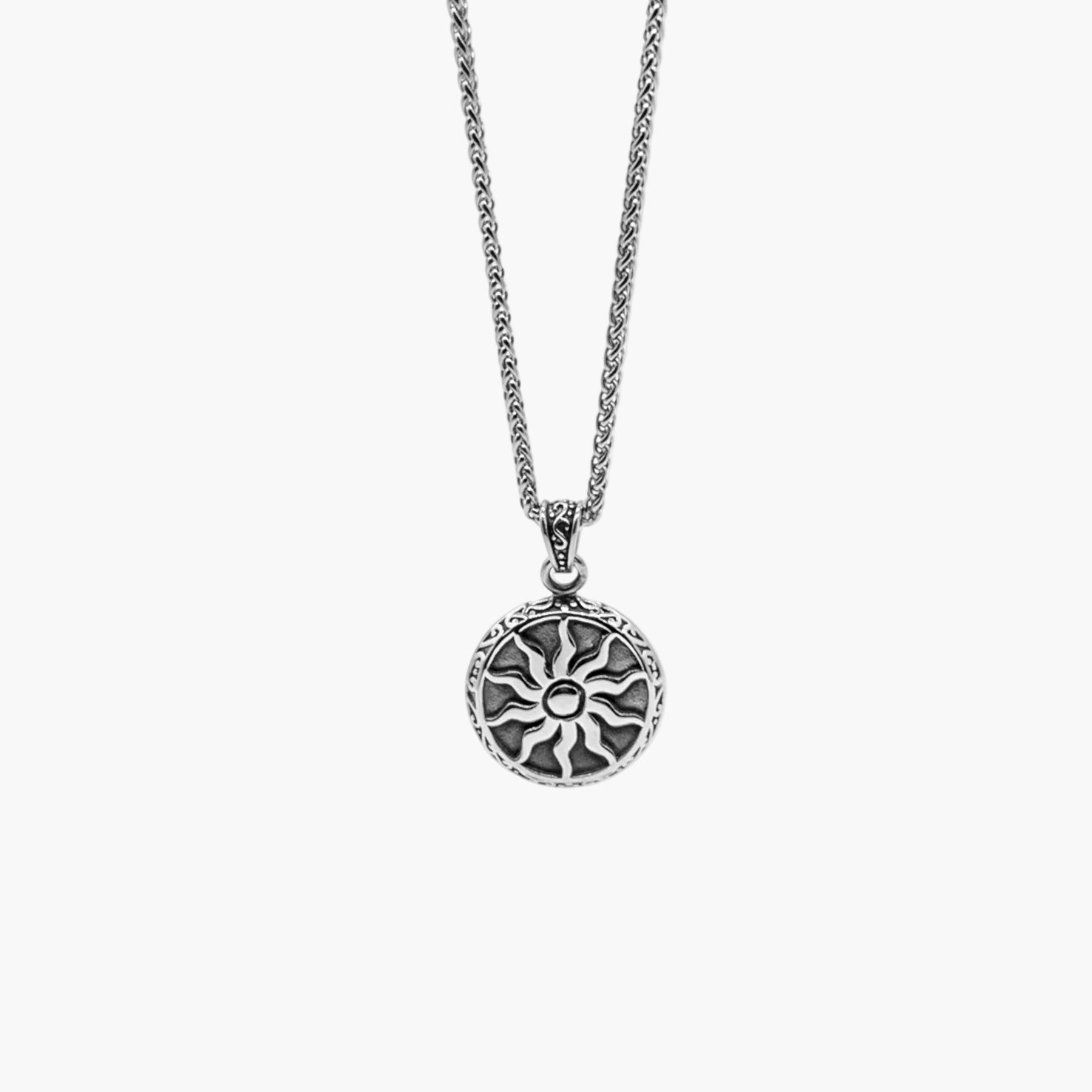 sun engraving detail on Solstice stainless steel pendant