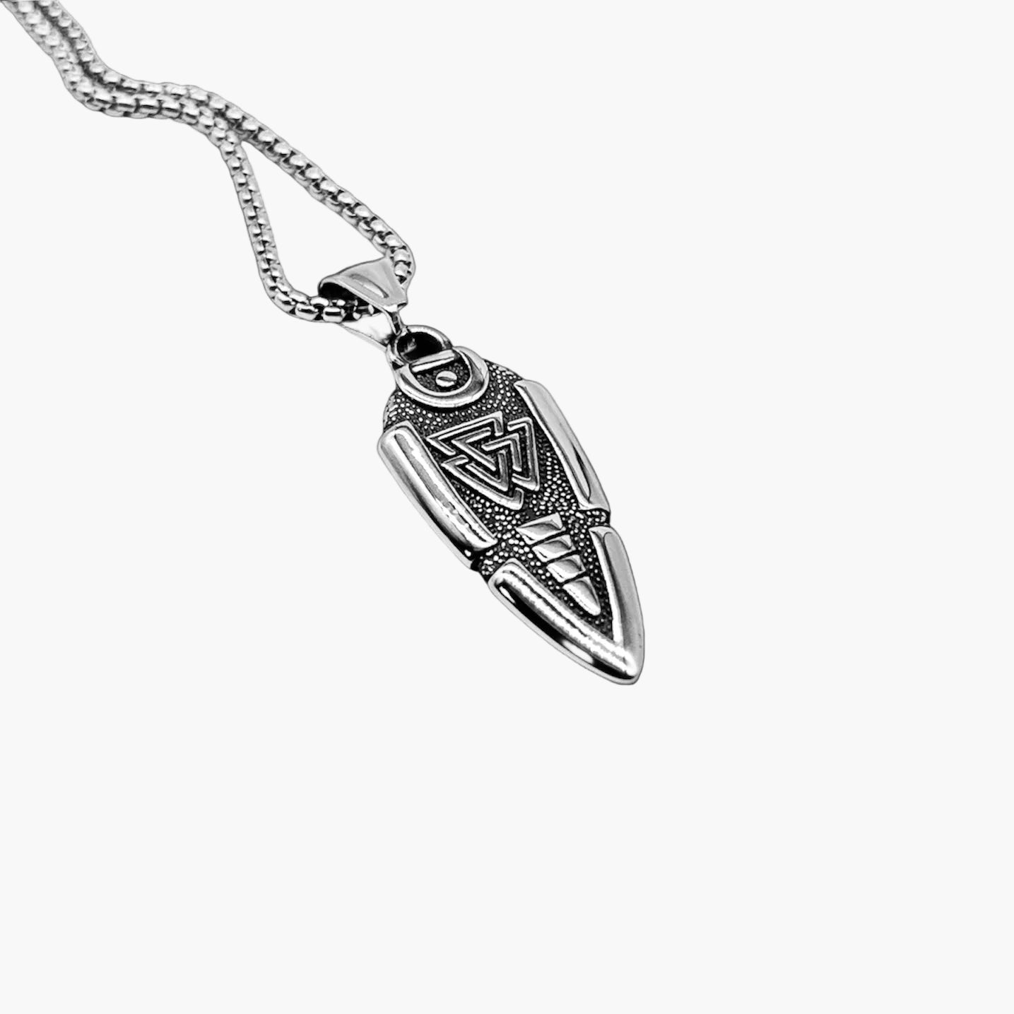 Angled left view of Vanguard Necklace highlighting sculpted pendant and polished stainless steel finish