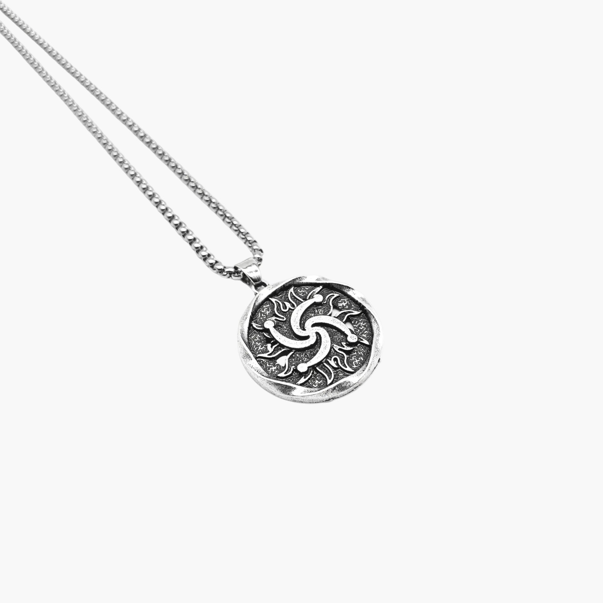 left angle view of Sól sun pendant in 316L stainless steel