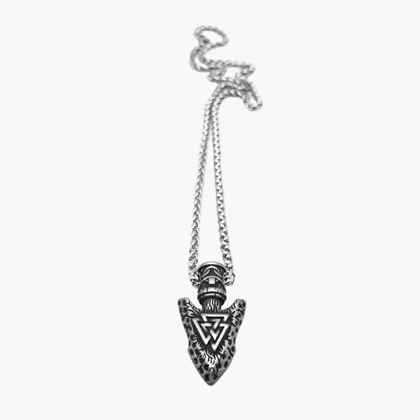 Flat view of Spearhead Amulet displaying subtle detailing along the silver-colored pendant