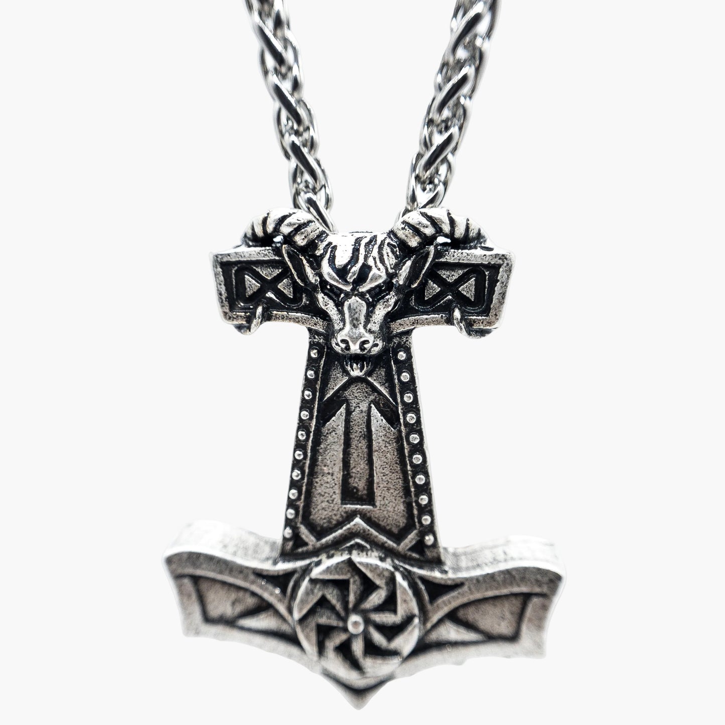 Norse symbol engravings etched across stainless steel chain close up