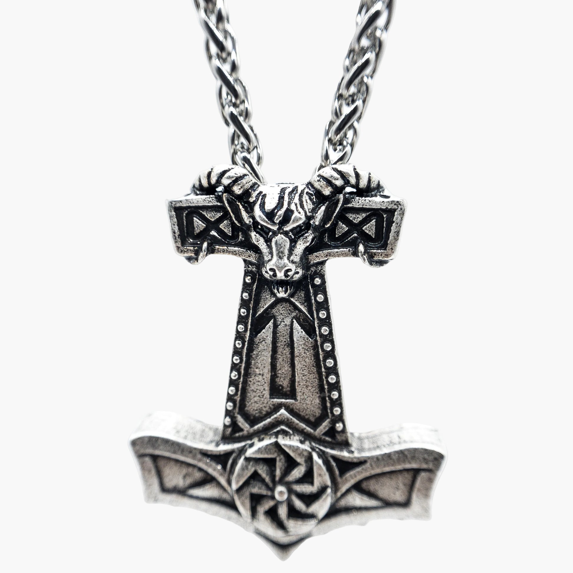 Norse symbol engravings etched across stainless steel chain close up
